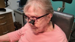 Dr. Long's patient reading with telescopic glasses.